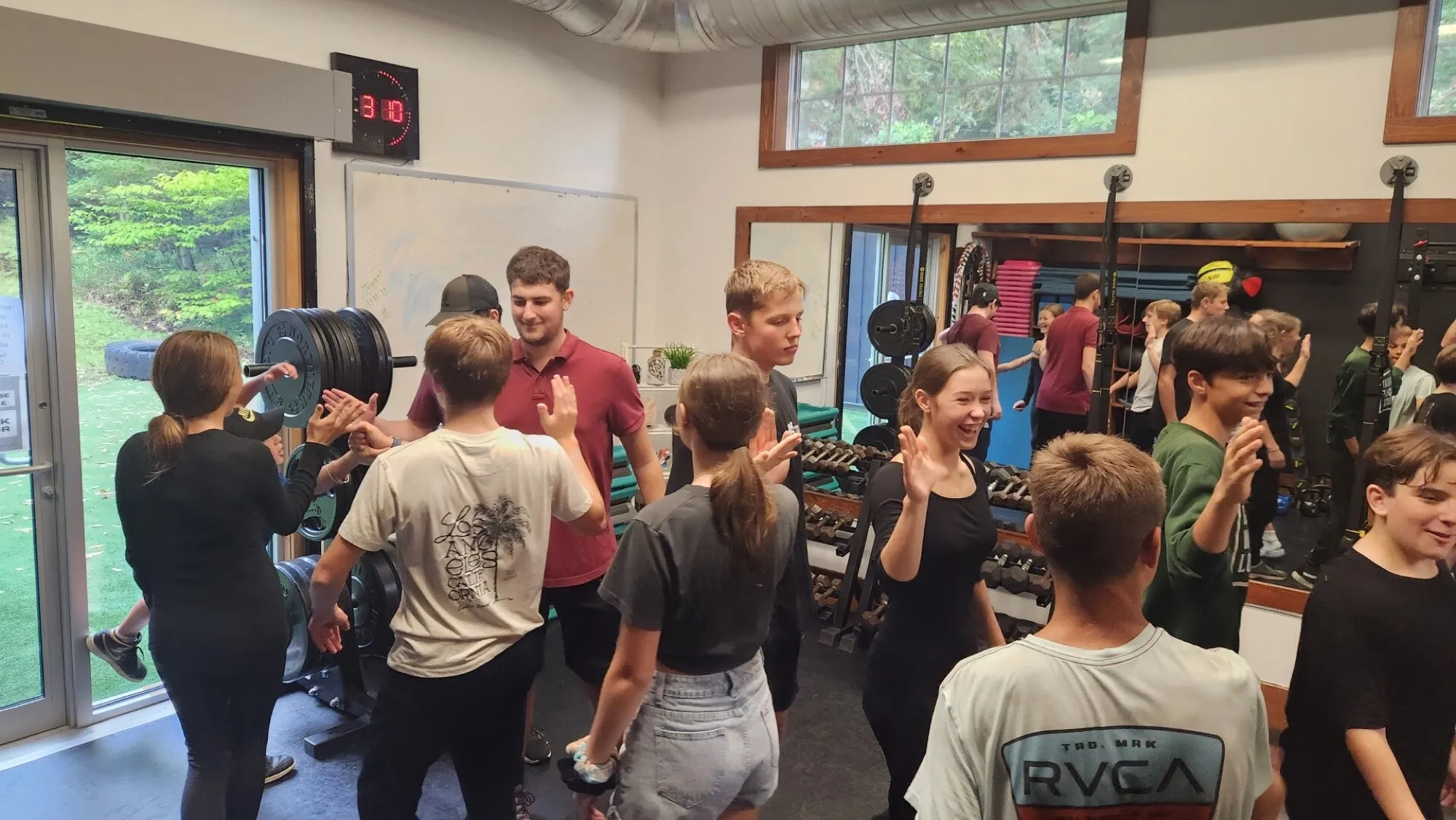 Students laughing together during a class in a fitness studio
